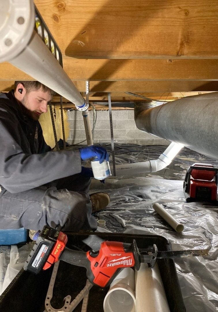 All-Pro Plumbing technician working in crawl space installing new pipes during a home repipe project in Kokomo, Indiana.