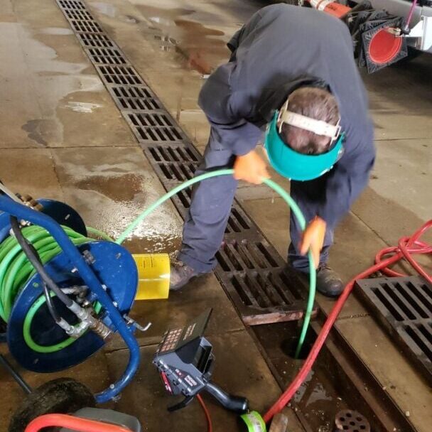 All-Pro Plumbing uses a Ridgid camera and hydro jetting equipment to clear a clogged floor drain in a garage, addressing a backup issue efficiently.