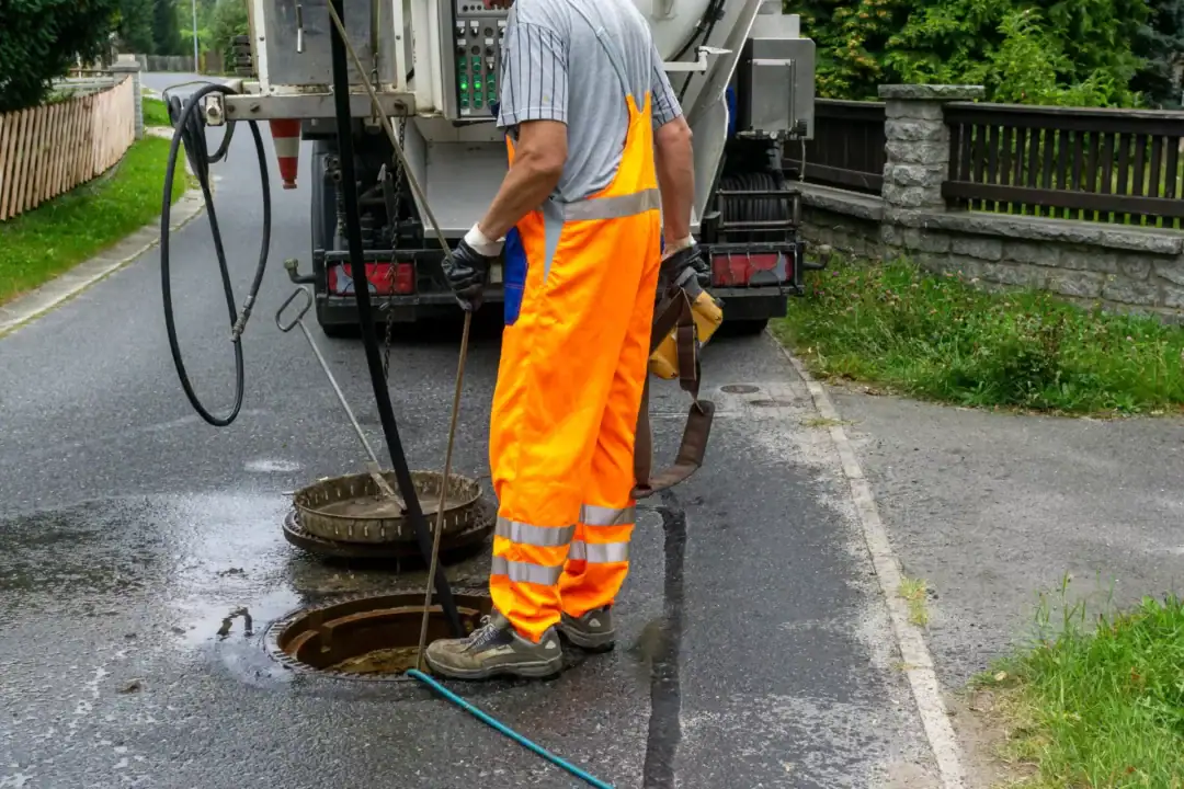 Plumber operating flex shaft for main line sewer camera inspection and clog removal in Kokomo, IN